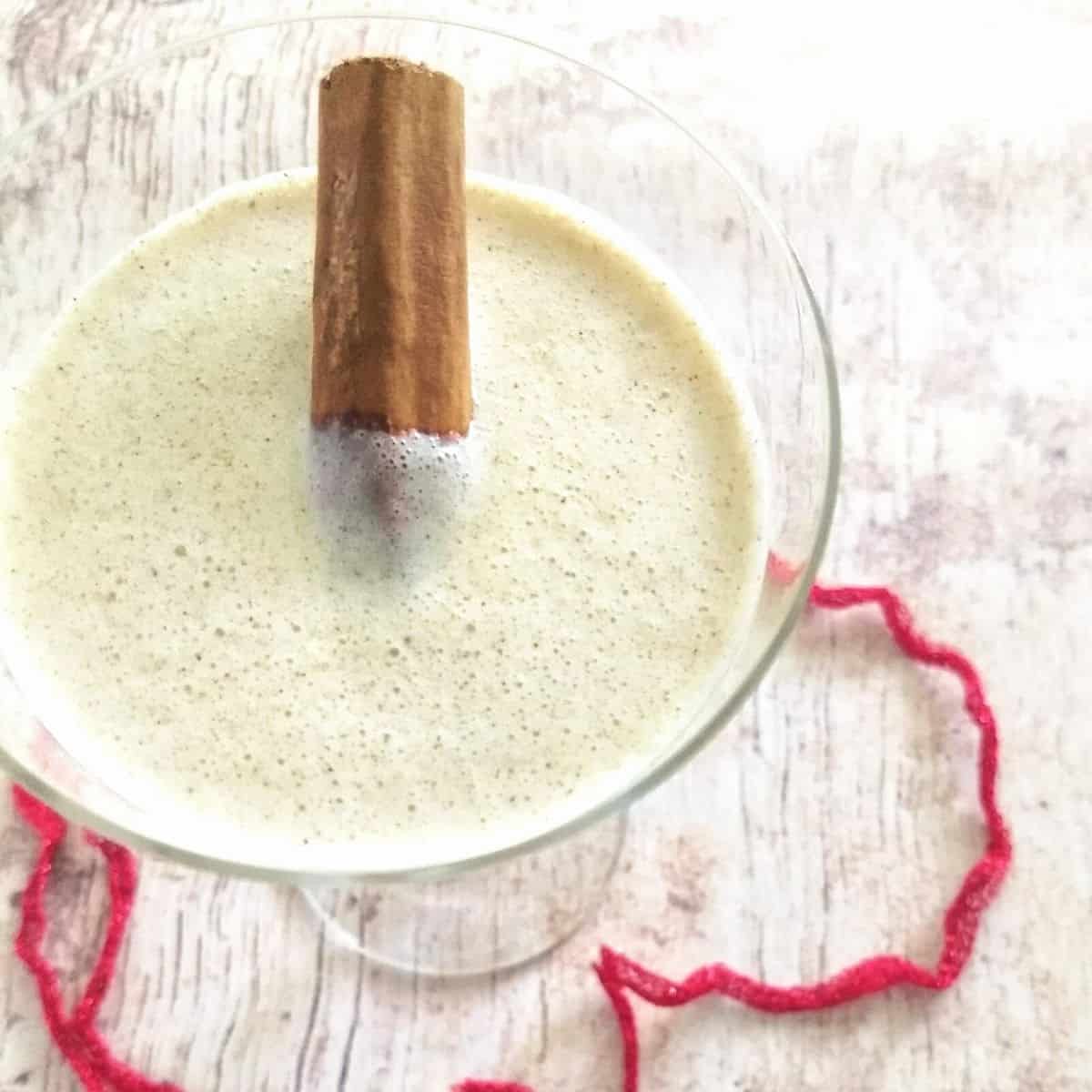 cinnamon stick in a glass of eggnog