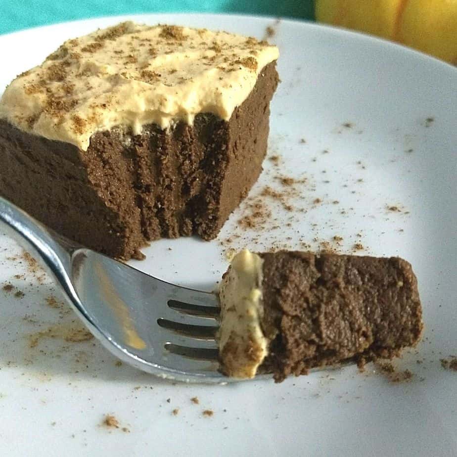 pumpkin brownies cut into with a fork on a white plate