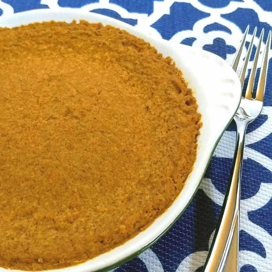 Pumpkin pie in dish with a fork on a blue and white mat 1024x1024 - Crustless Keto Pumpkin Pie| Egg Free