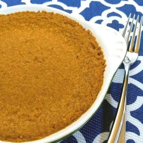 Pumpkin pie in dish with a fork on a blue and white mat 500x500 - Keto Cheesecake Crust: Graham Cracker Texture