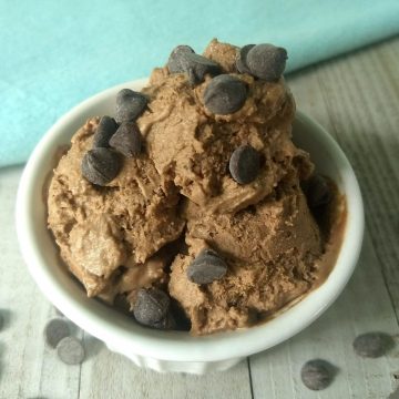 slight overhead shot of chocolate ice cream in a white bowl with chocolate chips