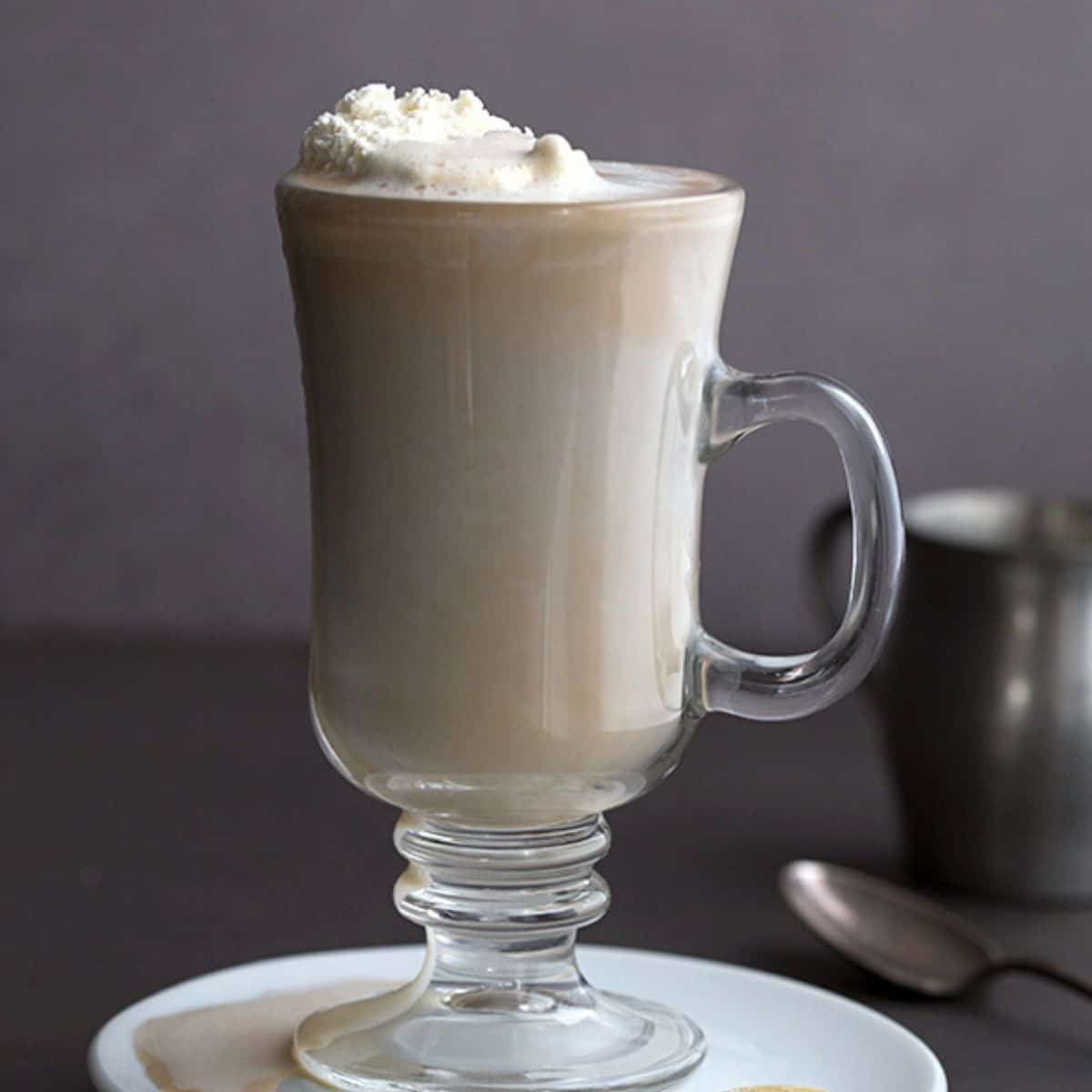 mocha with whipped cream on top in a glass