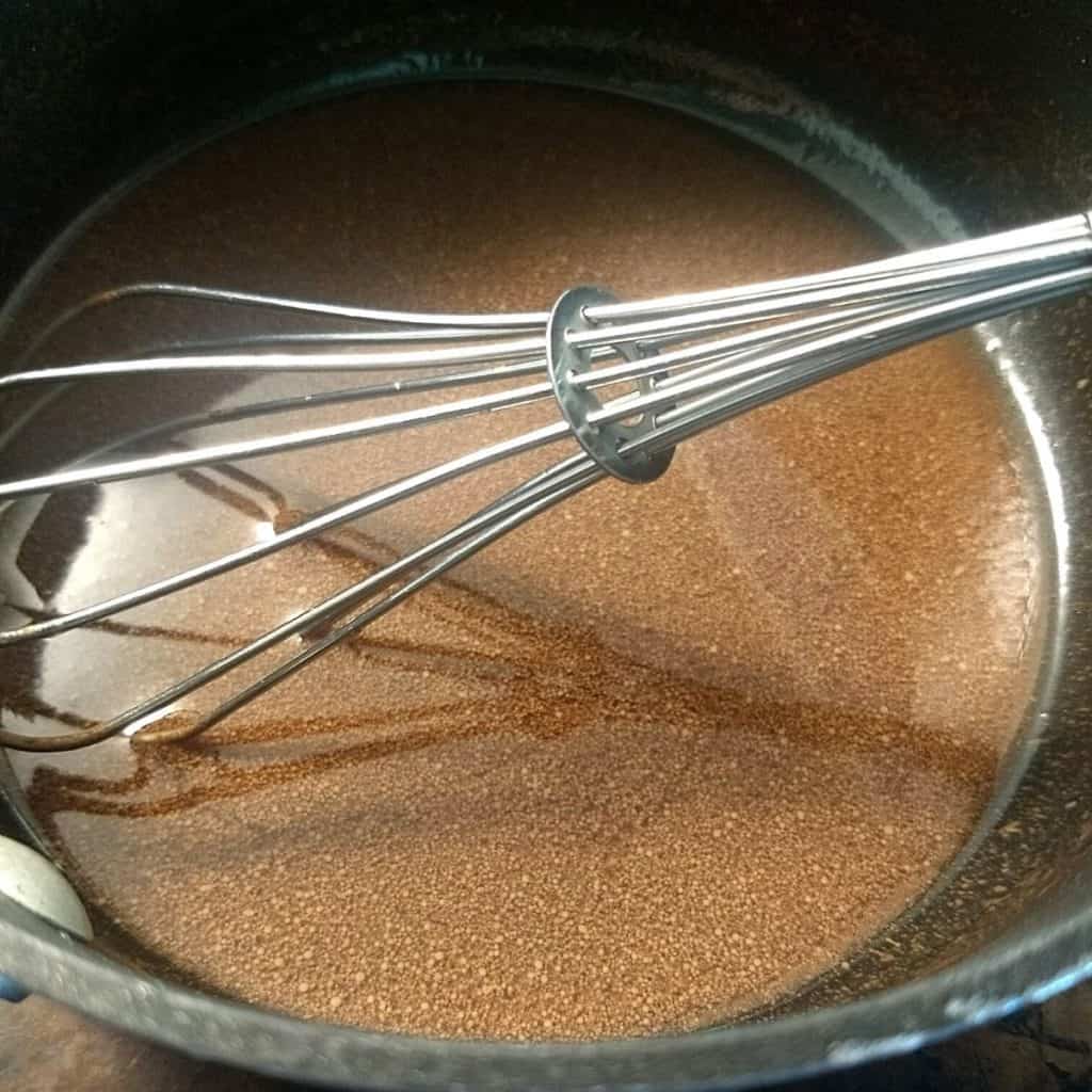 chocolate liquid in a pot with a whisk.