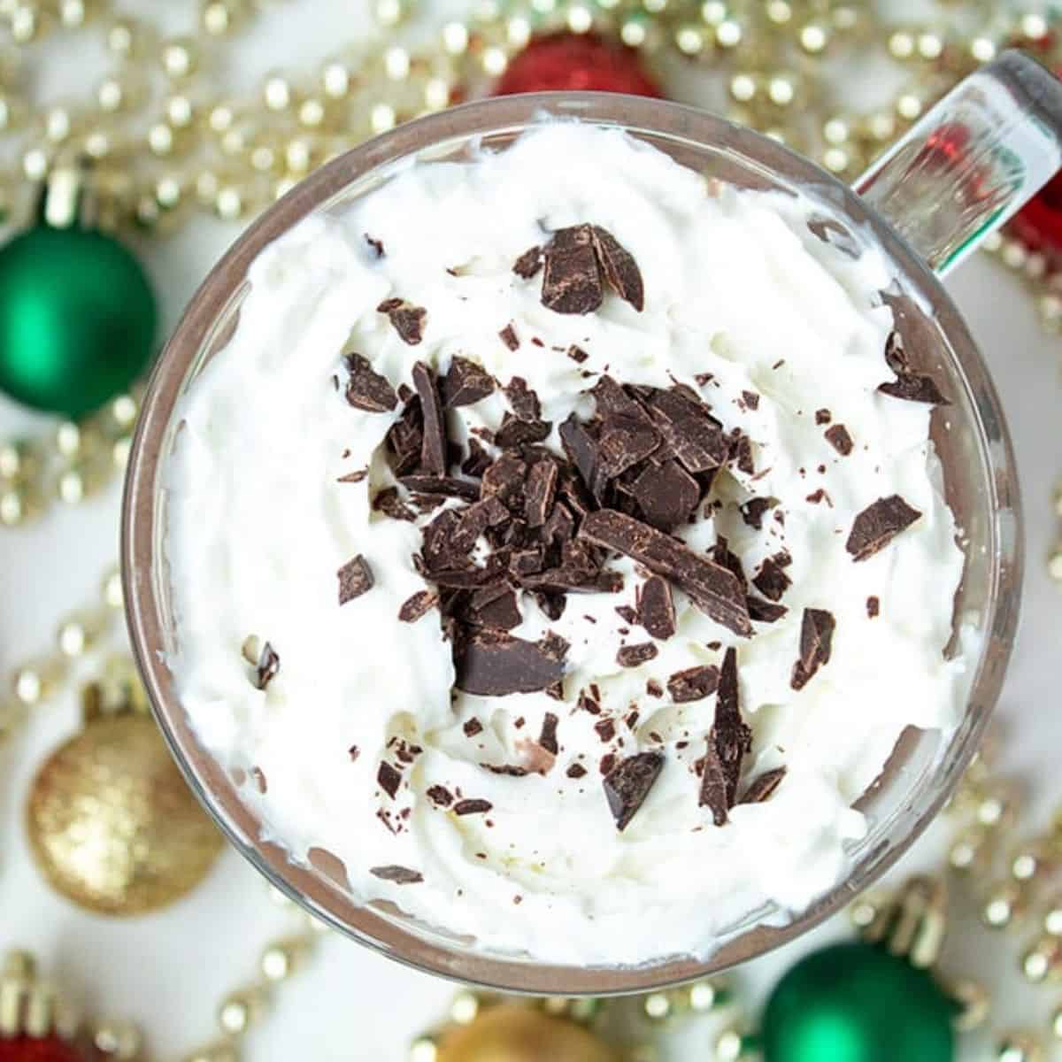 mocha with whipped cream with christmas decorations around