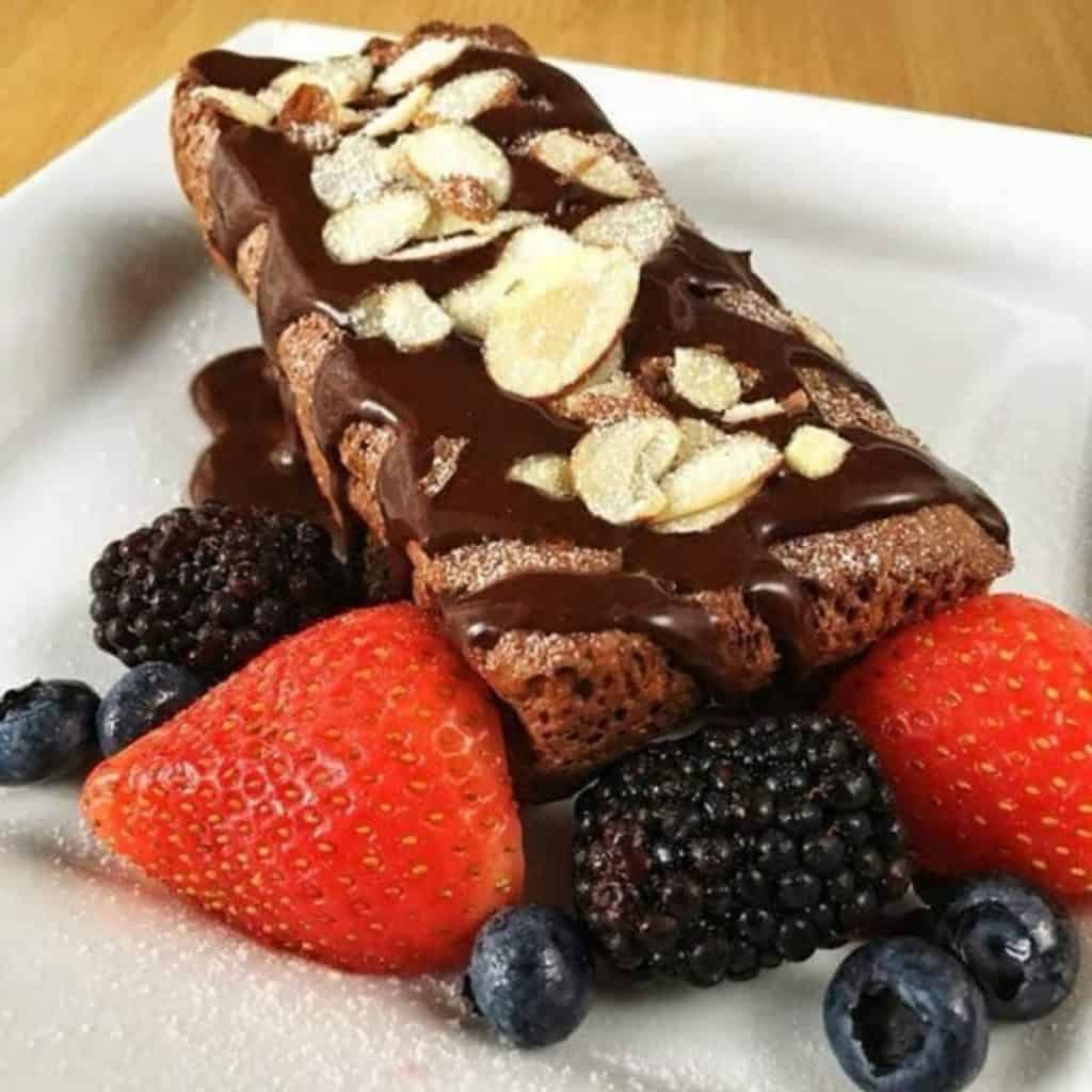 Chocolate egg loaf with berries and almonds on top