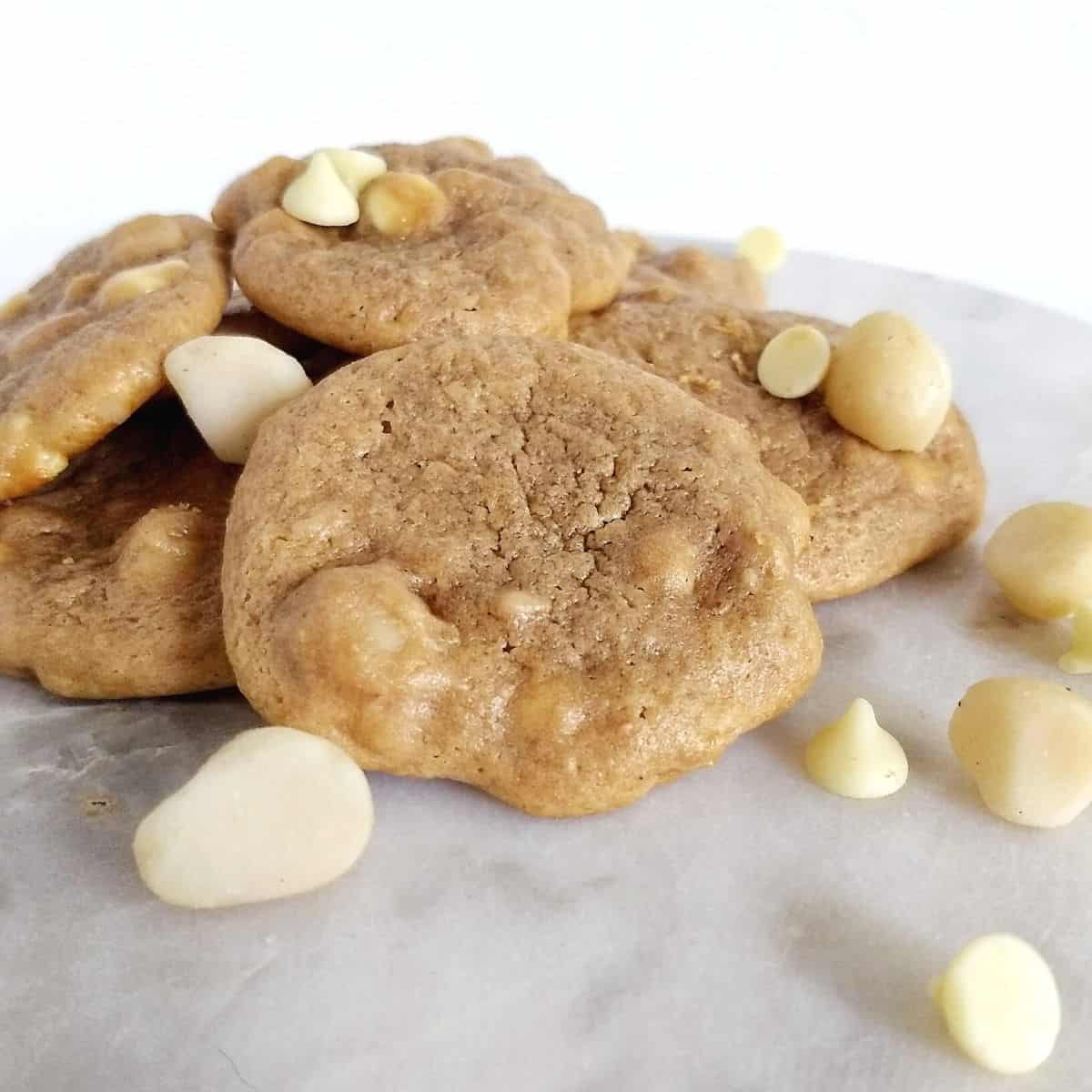 pile of cookies with macadamia nuts and white chocolate chips sprinkled on top