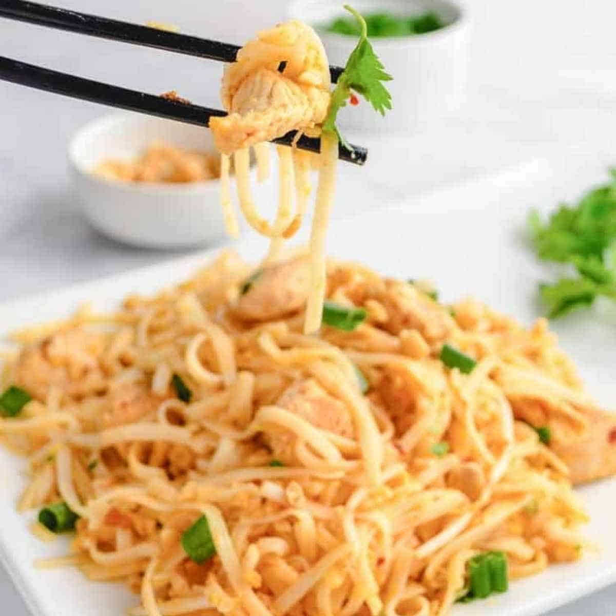 Chicken Pad Thai with a bite in chop sticks