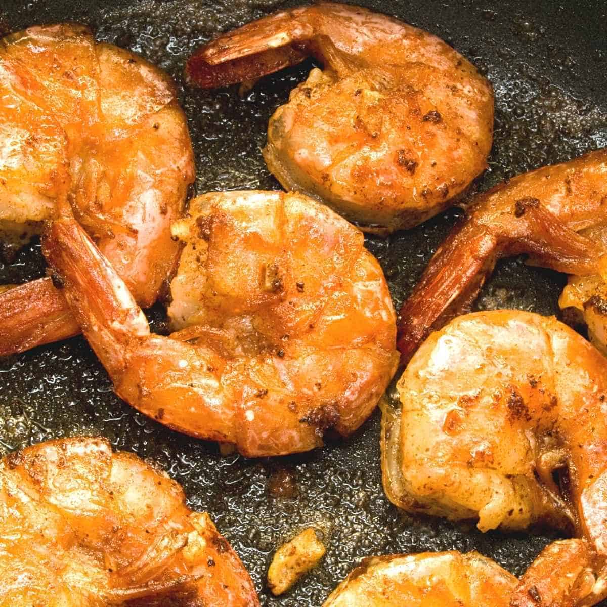 sauted shrimp in a black pan