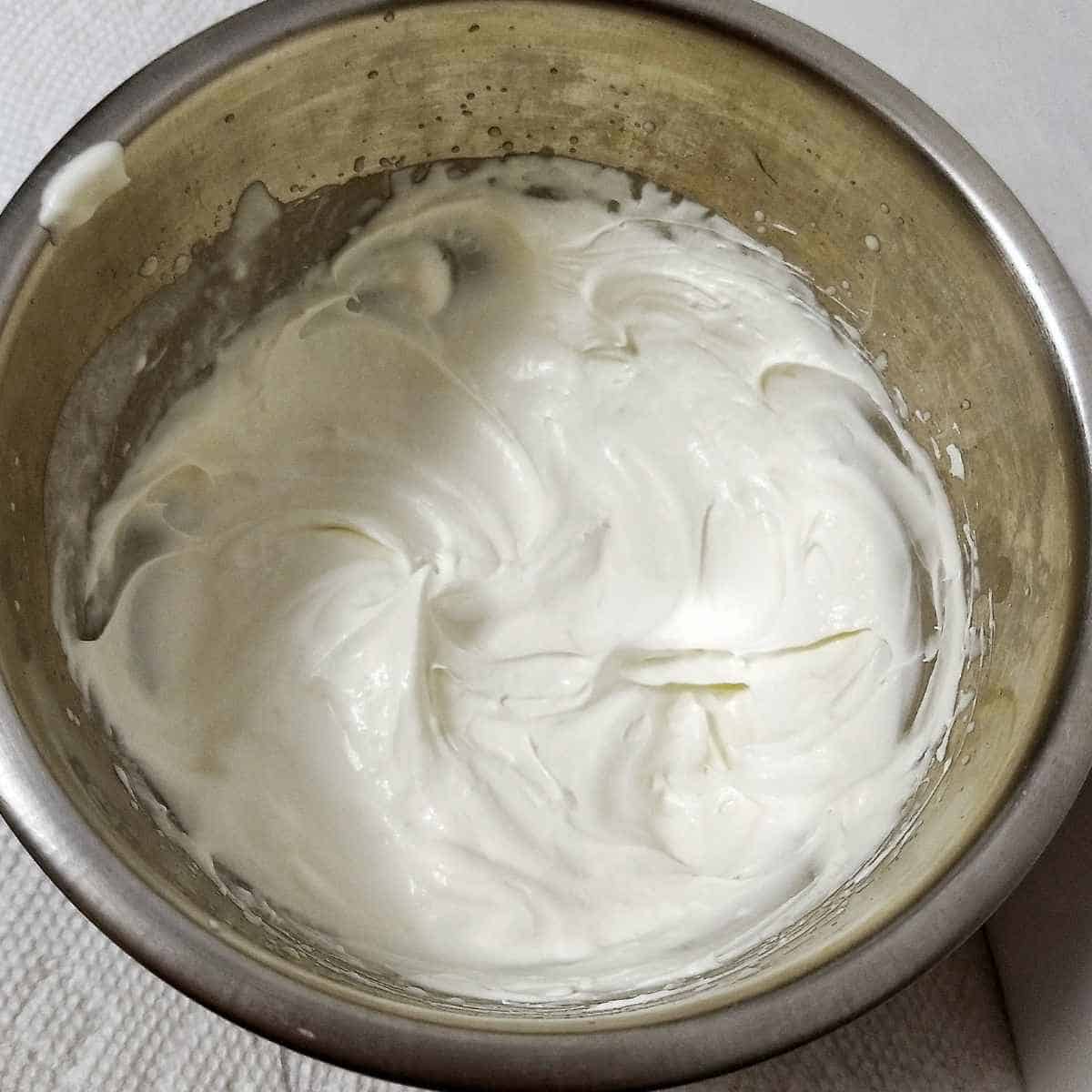 Metal bowl of finished white frosting