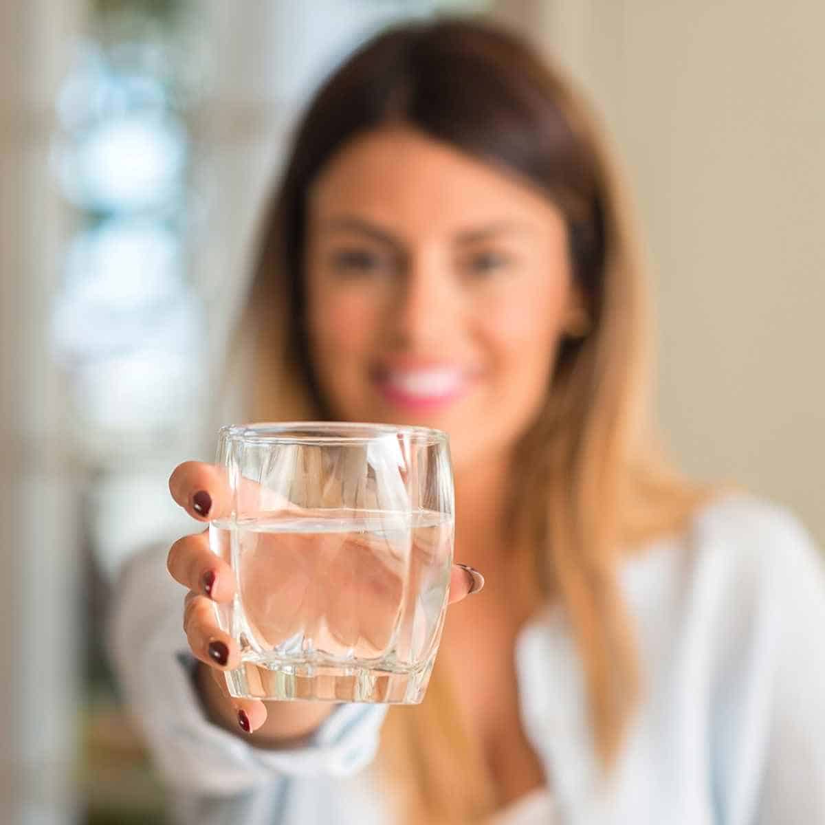 giving a glass of water - The Pros And Cons Of The Keto Diet