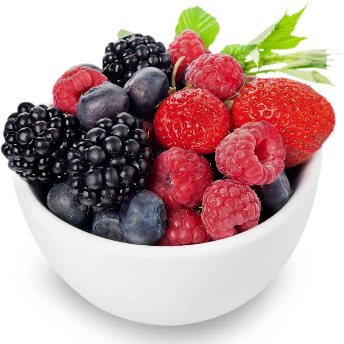 white bowl of blueberries, strawberries, raspberries, and blackberries