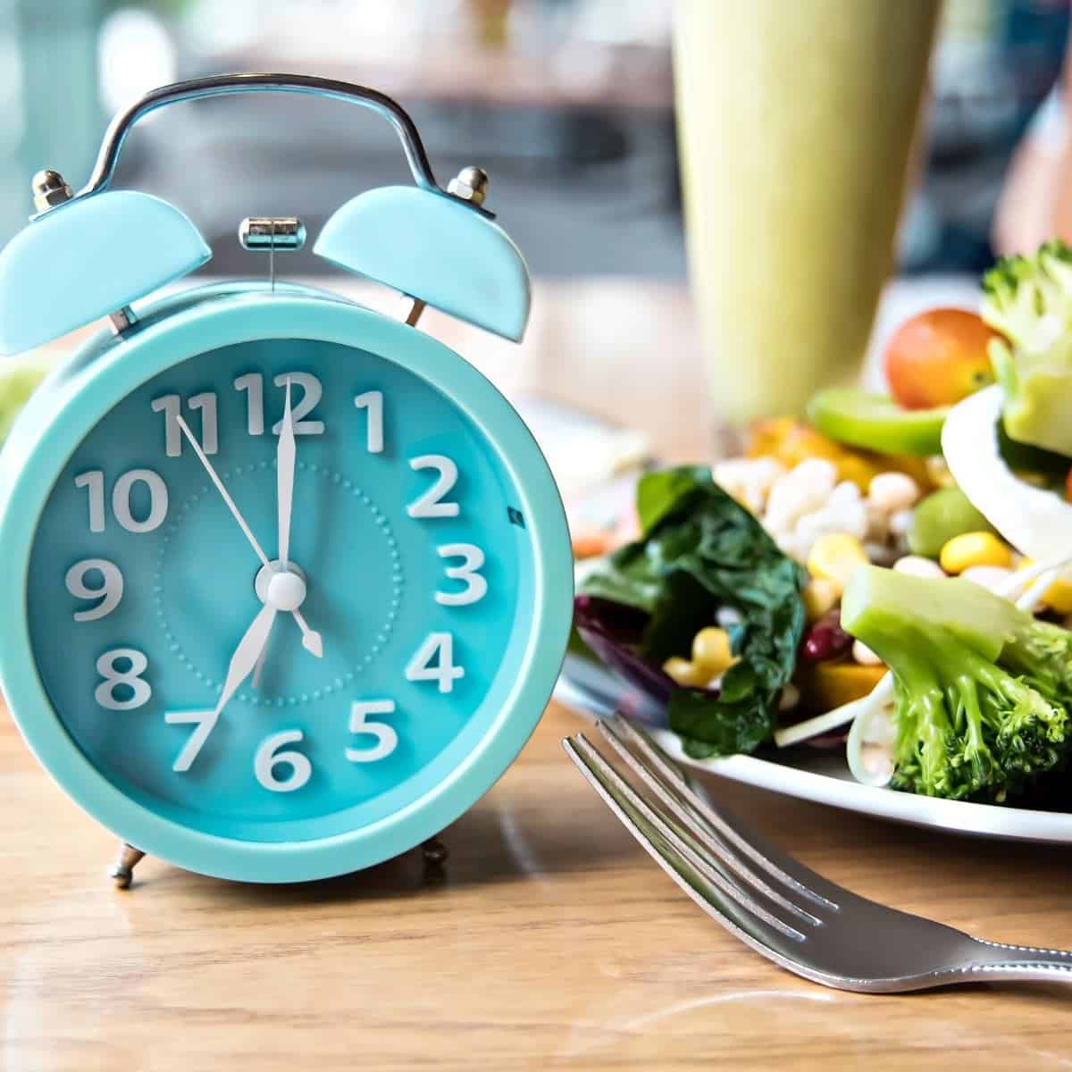 blue clock next to a salad