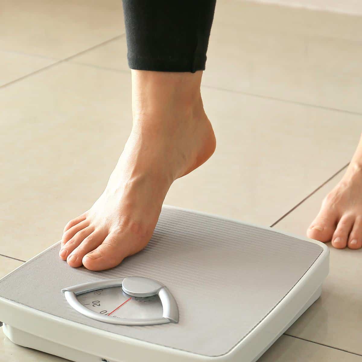 a foot steping on a scale