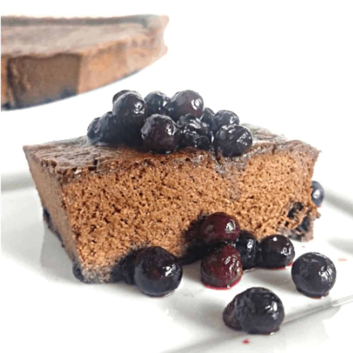 chocolate cake slice with blueberries on top