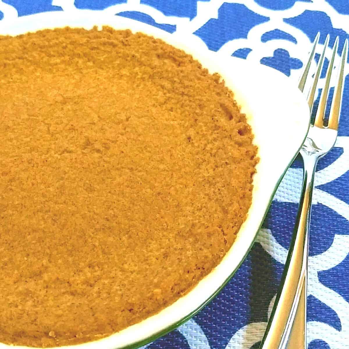 pumpkin pie in a dish with a fork to the right