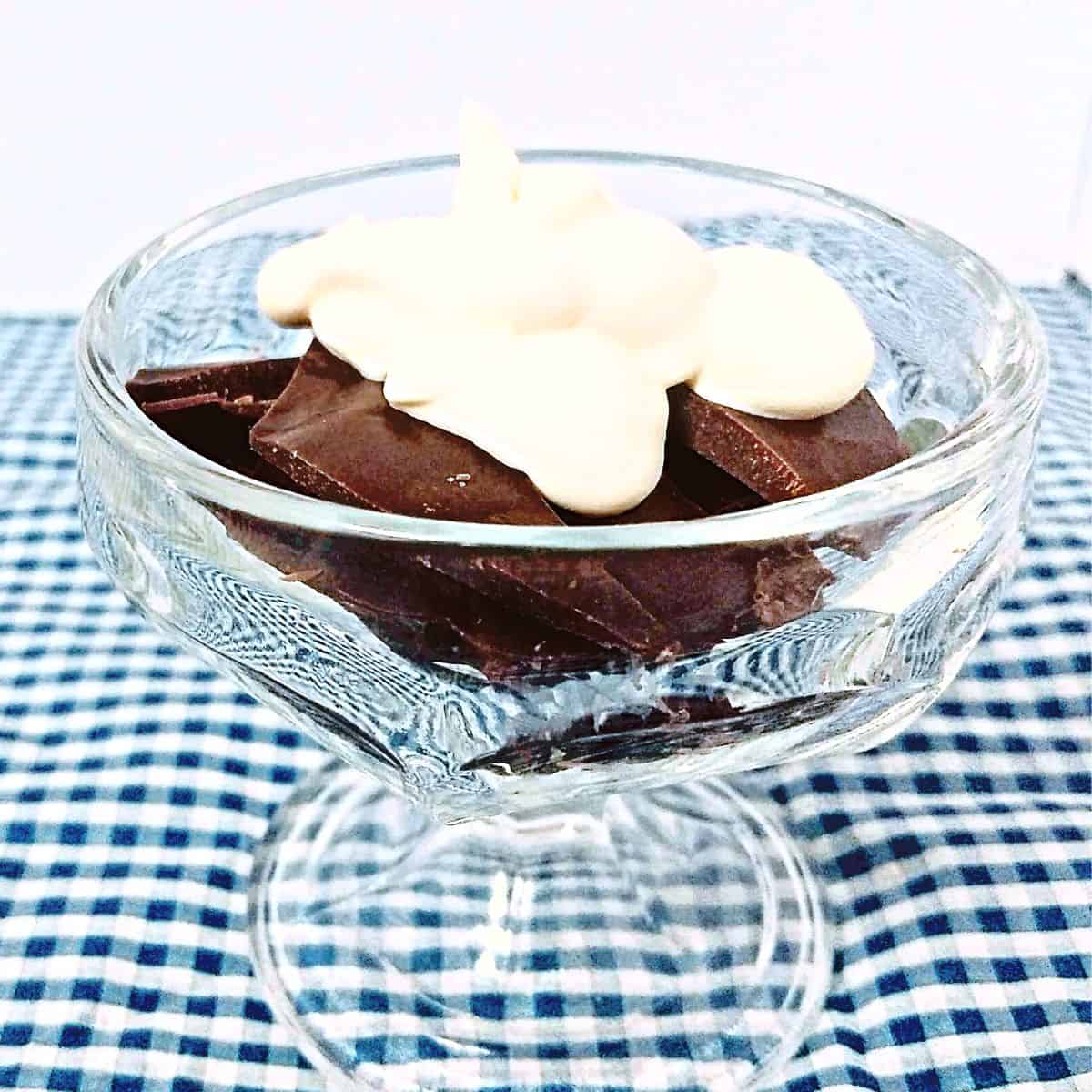 chocoalte in a clear glass with whipped cream on top