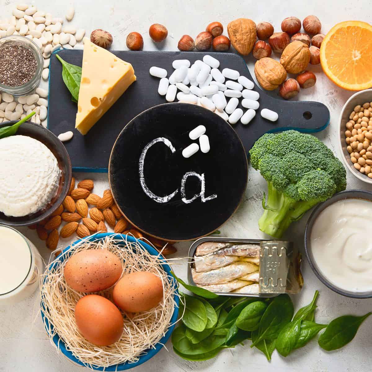 Ca on a chalkboard with foods near by