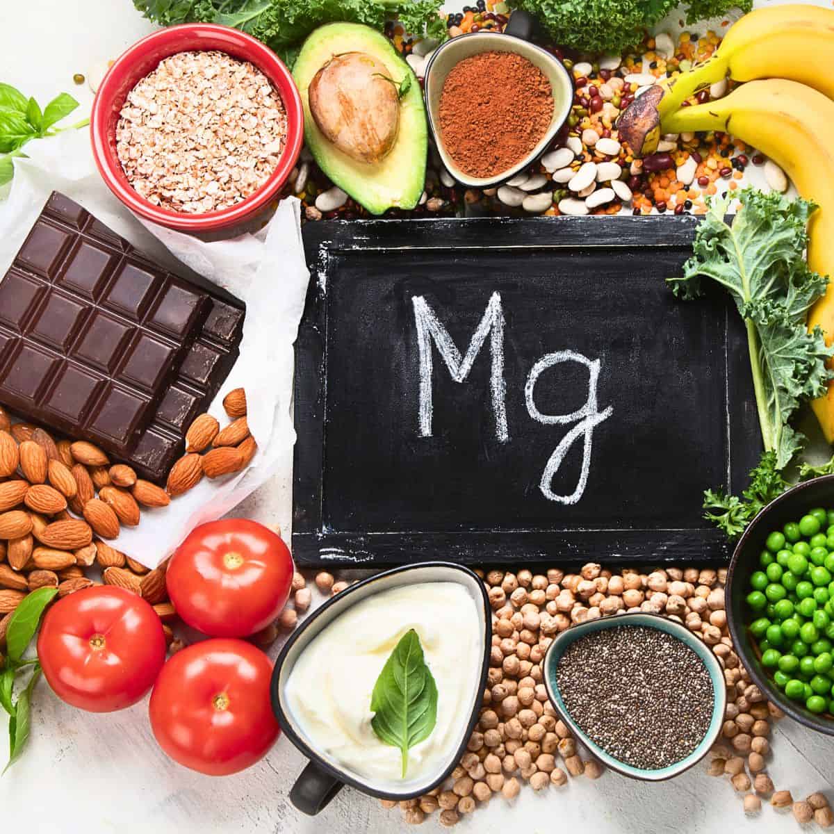 Mg on a chalkboard with foods near by